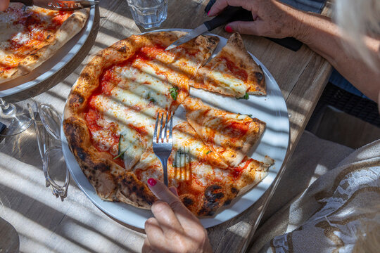 Sharing Pizza at a Restaurant During the Afternoon