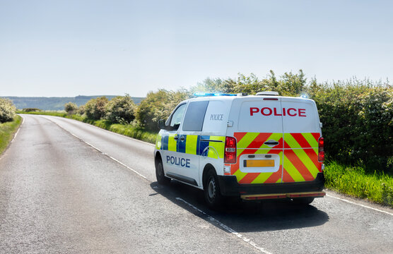 Police siren flashing blue lights on police van driving to accident or crime scene