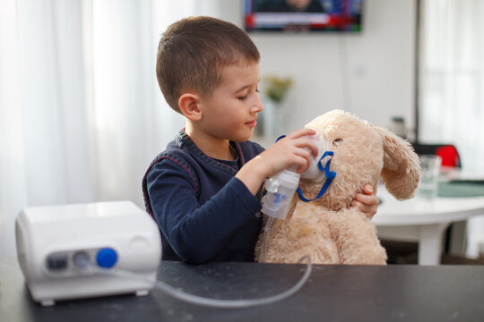 Cute Boy Playing Doctor Giving Nebulizer Inhalation Treatment to Stuffed Toy, Pediatric Respiratory Care and Empathy Concept.