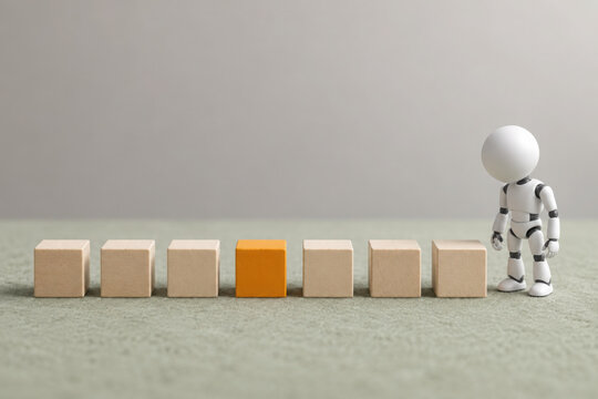 Artificial intelligence concept with small robot observing wooden blocks with one orange block symbolizing ai observability and insight