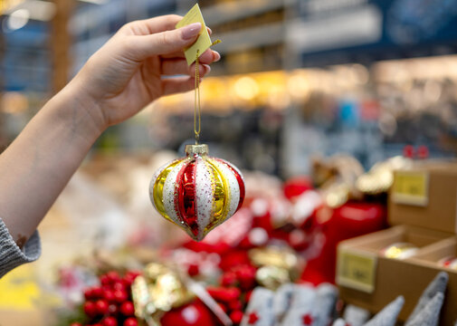 Holding a colorful Christmas coloring page ornament