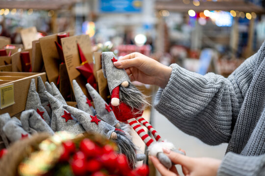 Holding handmade Christmas gnome in shop