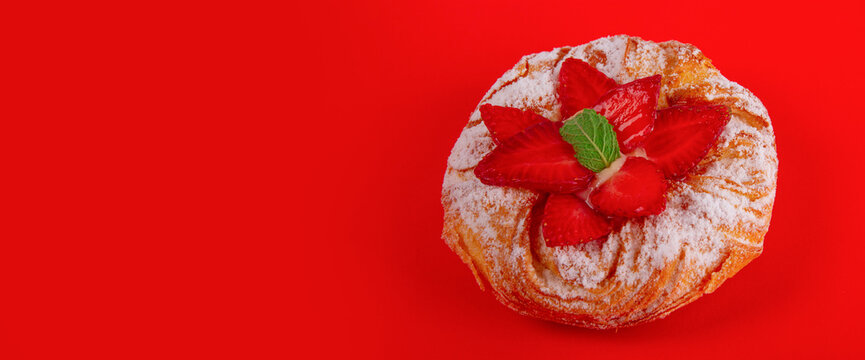 Strawberry puff pastry and mint leaves isolated on red background