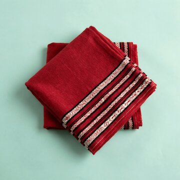 Folded red cotton fabric cloth with traditional embroidered geometric tribal patterns
