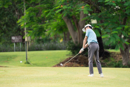 Professinal golf player on golf course. Pro golfer taking a shot. sport, golf, golfer, golfing, club,	