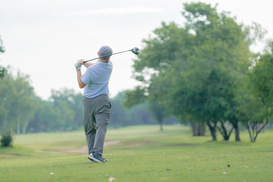 Professinal golf player on golf course. Pro golfer taking a shot. sport, golf, golfer, golfing, club,	