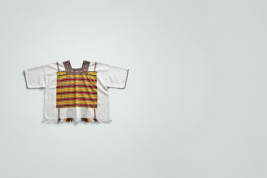Traditional handmade mexican huipil blouse with colorful woven striped pattern