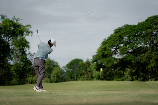 Professinal golf player on golf course. Pro golfer taking a shot. sport, golf, golfer, golfing, club,	