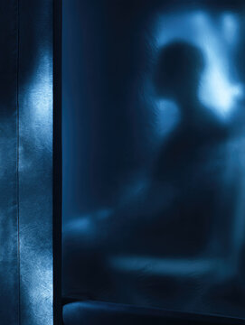 Mobile quarantine tent isolation metaphor extreme close up showing blurred silhouette behind vinyl, quiet clinical tension, blue light, large negative space