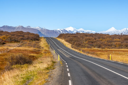 Snow covered mountain view in the Borgarbyggd region of western Iceland, as seen from the Route One ring road near Fiflholt. Autumn colours and main road.