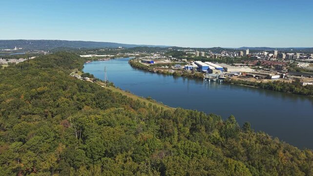 Drone aerial of downtown city of Chattanooga Tennessee in United States with roads, buildings, museums, and attractions along highway and with Choo Choo signage on top building rooftops in moving shot