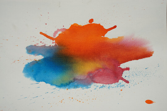 Colorful watercolor paint splash with blended orange, blue, yellow, and pink pigments on a white background