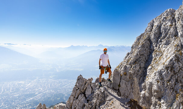 Via Ferrata Climber Ascending a Rocky Wall in the Alps