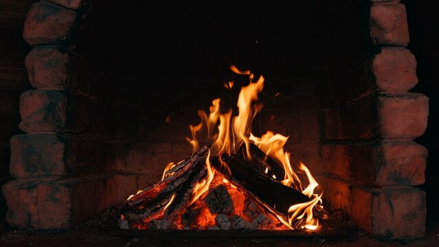 Burning Logs and Glowing Embers in a Fireplace - Close-Up