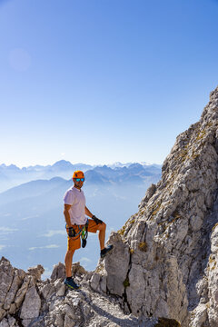 Via Ferrata Climber Ascending a Rocky Wall in the Alps