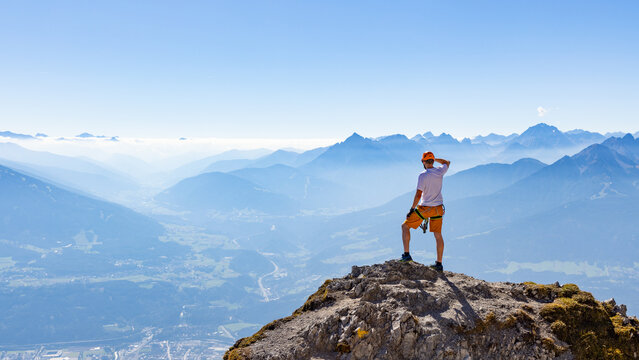 Via Ferrata Climber Ascending a Rocky Wall in the Alps