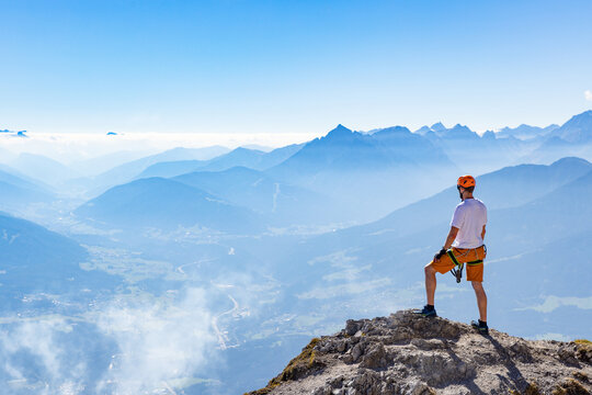 Via Ferrata Climber Ascending a Rocky Wall in the Alps