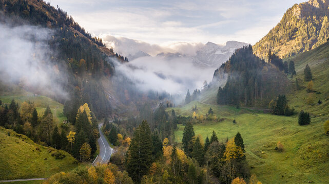 Morning Alpine Valley with Clouds Below the Mountain Peaks