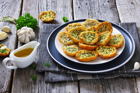Garlic bread crostini topped with parsley on plate