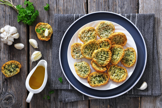 Garlic bread crostini topped with parsley on plate