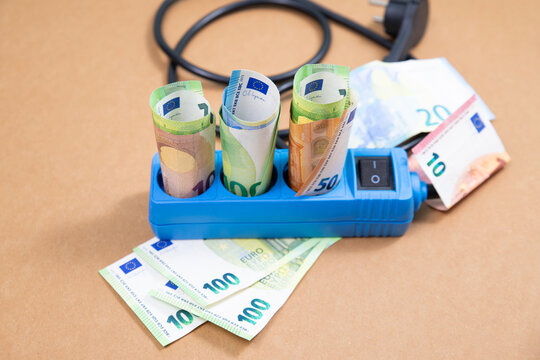 Electricity power socket with Euro banknotes, high expensive energy price, economy crisis, money for paying bill, increase costs of living, inflation and social issues