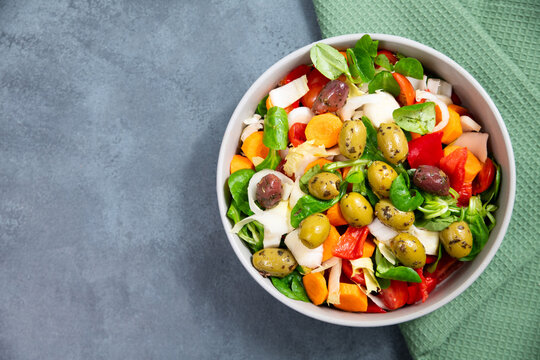 Salad bowl with lettuce, chicory, olives, cucumber, spinach, tomatoes and herbs, healthy mediterranean food, homemade meal, lifestyle and nutrition diet