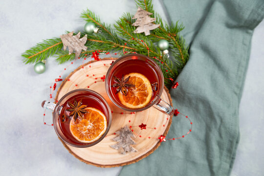 Hot mulled red wine or tea, winter christmas punch with fruits, cinnamon, star anise spice and lemon, hot alcohol drink, advent holiday season