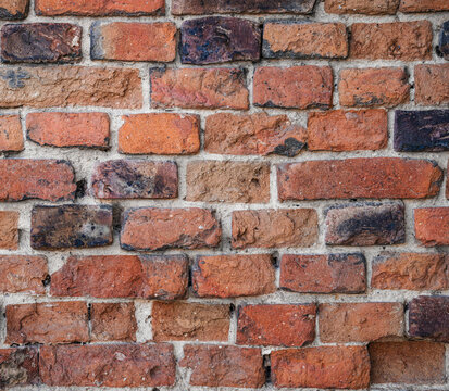 Red brick wall texture, weathered clay blocks close up, masonry backdrop