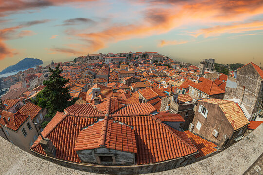 Terracotta rooftops of Dubrovnik Old Town, Croatia, viewed from the historic city walls, with the Adriatic Sea and Lokrum Island creating a scenic Mediterranean backdrop.