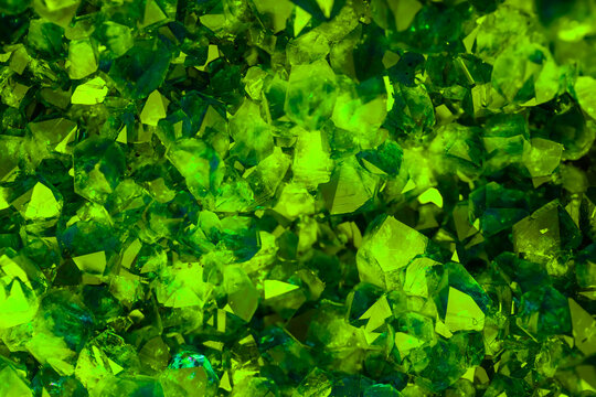 Green crystal mineral stone. Gems. Mineral crystals in the natural environment. Texture of precious and semiprecious stones. Seamless background with copy space colored shiny surface of precious stone