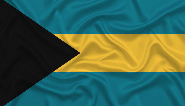 National flag of the bahamas with black triangle and blue and yellow stripes proudly displayed.