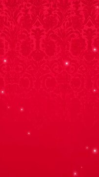 Red ornamental damask pattern with softly drifting glowing particles across a decorative abstract field. Invitation design, holiday greeting, and wedding media.