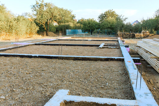 Workers are setting up foundation for new building in rural area site.