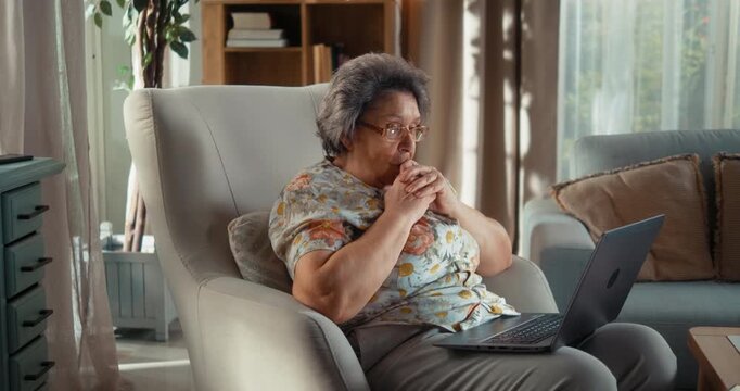 Senior mother becomes confused after encountering a problem on her laptop, while her adult daughter patiently shows her what to type and guides her through the solution step by step.