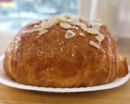 Almond croissant on a plate for breakfast