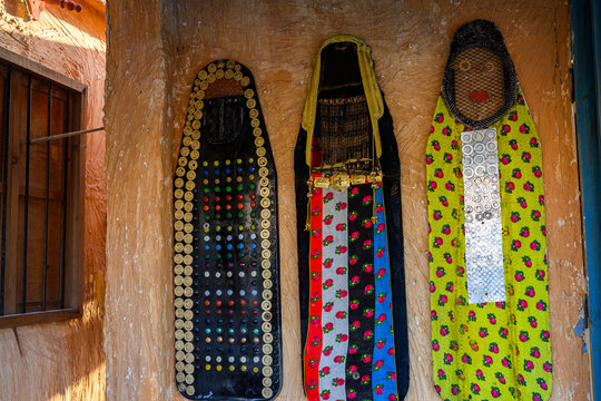 Doha, Qatar &ndash; November 29, 2023: Katara Cultural Village heritage shops showcase ancient women's attire and burqas embroidered with beads and golden jewelry documenting women's adornment in the past.