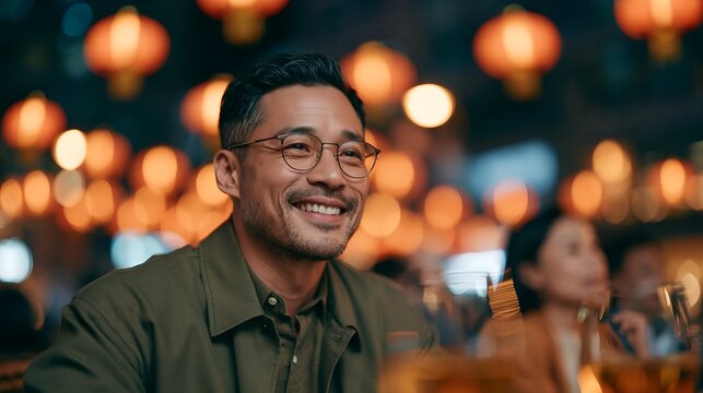 Smiling man in cozy, lantern-lit restaurant setting