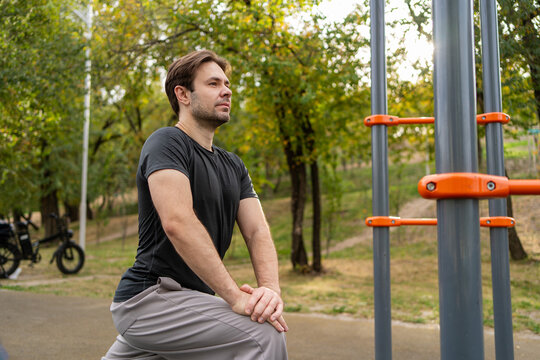 Man exercise at outdoor fitness area in city park