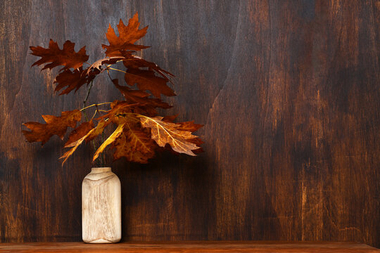 Wooden vase with autumnal bouquet