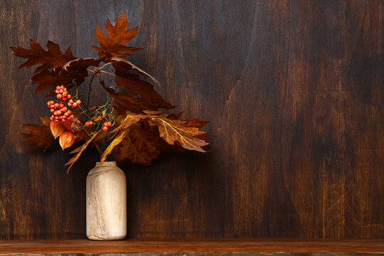 Wooden vase with autumnal bouquet