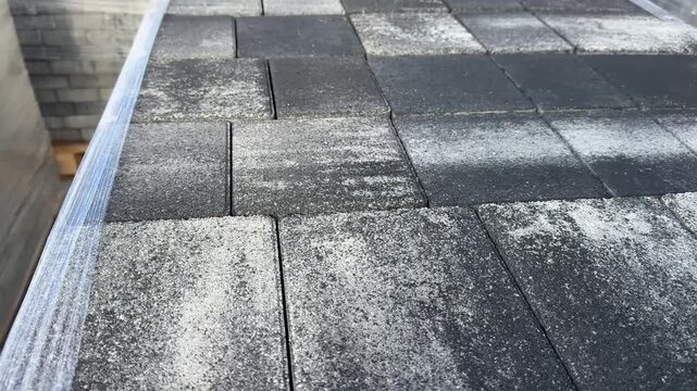 Pallets ofPallets of dark grey concrete paving slabs wrapped in plastic film in storage. dark grey concrete paving slabs in outdoor storage. High quality 4k footage
