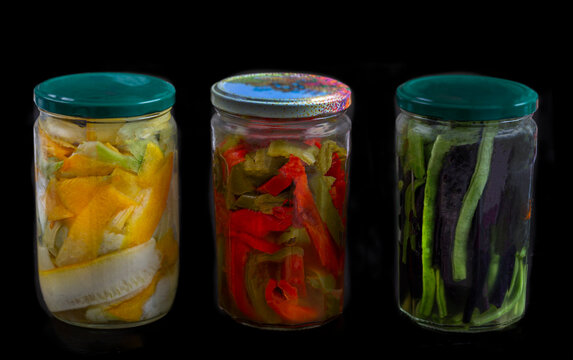 Jars of Pickled Vegetables on a Black Background