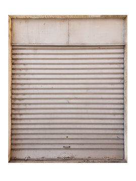 Closed weathered metal roller shutter door of  retail shop or garage isolated - background texture of industrial steel rolling security gate protecting  storefront or warehouse entrance.
