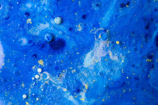 Blue liquid marble abstract with bubbles and cosmic fluid texture