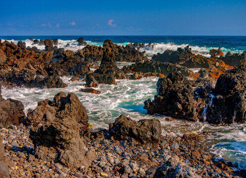 Waves crash on the rocky north shore of Maui, Hawaii