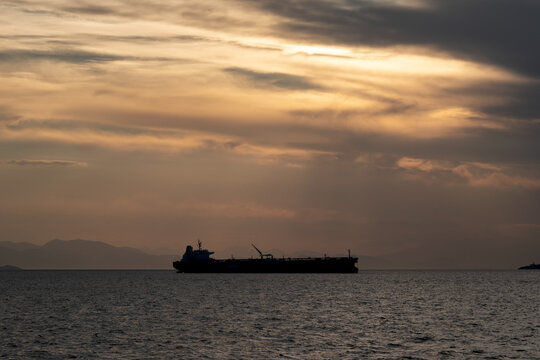 
Crude oil tanker in the sea at fiery sunset. Oil and gas industry. Tankers crude oil carrier ship designed for transporting grude oil