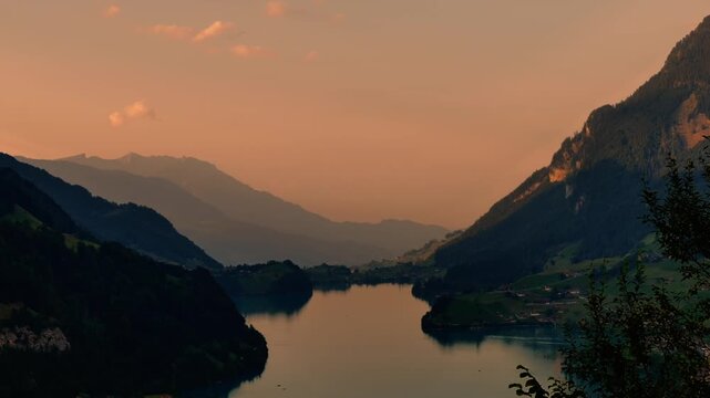 Panoramic View over Lake Lungern and Village with Mountainscape in Dusk in Summer in Lungern, Obwalden, Switzerland