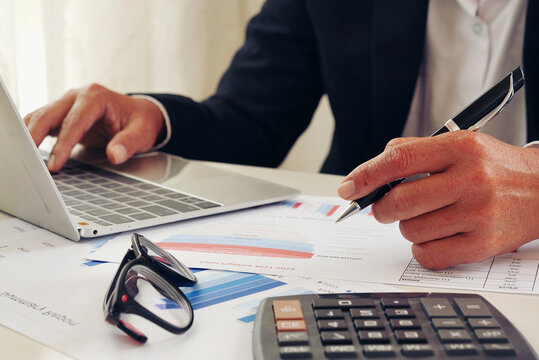 Close up businesswoman hands audit accountant using calculator. business graph chart working at home office. Woman Hands working home do accounting small business. Audit Businesswoman at office desk