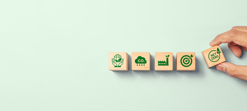 Sustainable Development Concept with Wooden Blocks Showing Environmental Protection, Carbon Emission Reduction, Green Energy, Goal Setting, and Net Zero Symbols Representing Eco-Friendly Strategies