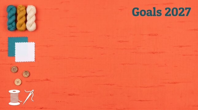 Goals 2027 creative crafting flat lay concept featuring colorful yarn skeins fabric swatches buttons and sewing thread on a textured coral linen background template for presentation